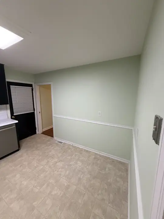 Breakfast nook with pale green walls and white chair rail in Chattanooga, TN