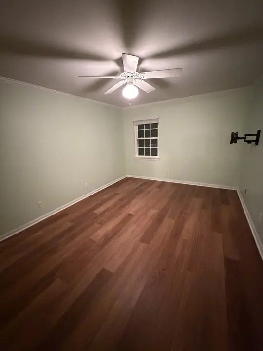 Bedroom painted pale green with white crown molding in Chattanooga, TN