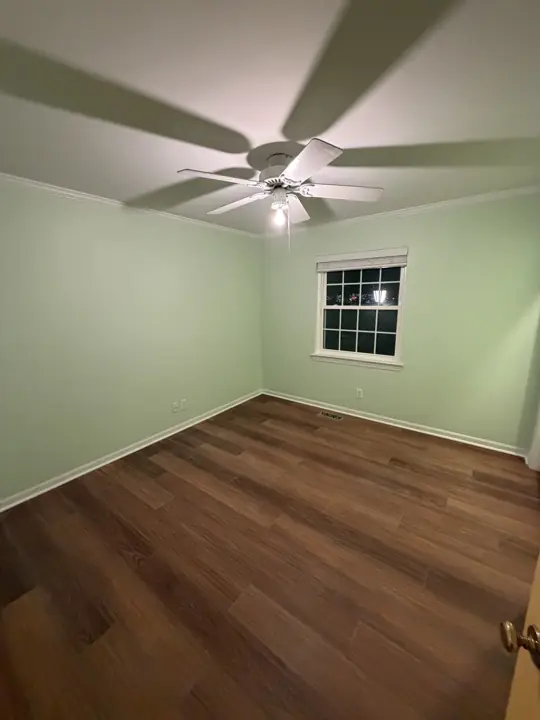 Mint green bedroom with white crown molding and window trim in Chattanooga, TN