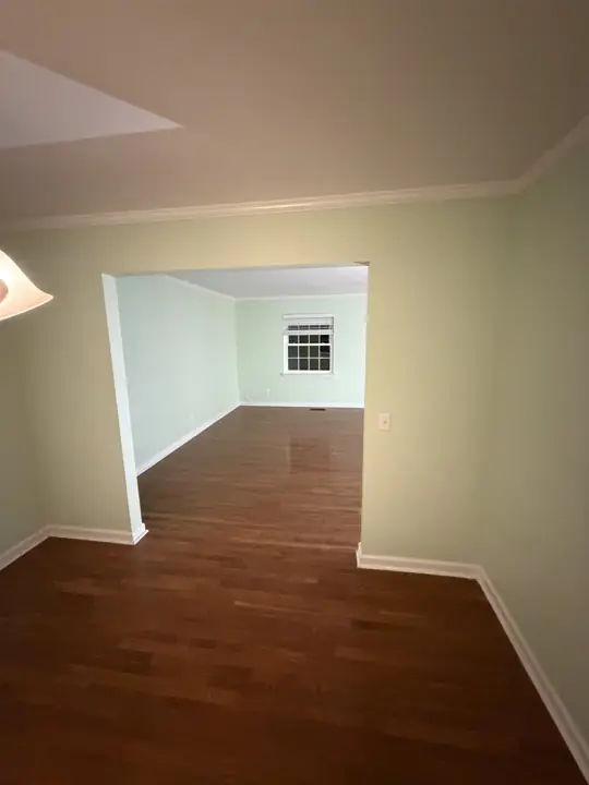 Cased opening from dining room to mint green living room in Chattanooga, TN