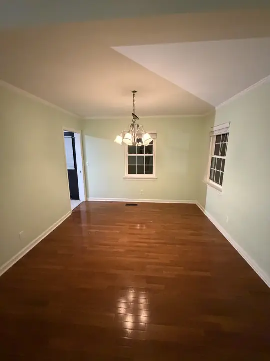 Dining room with mint green walls, chandelier and raised ceiling section in Chattanooga, TN