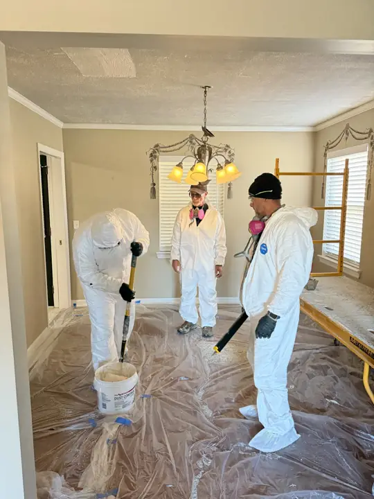 Painting crew in protective suits preparing to remove ceiling texture in Chattanooga, TN