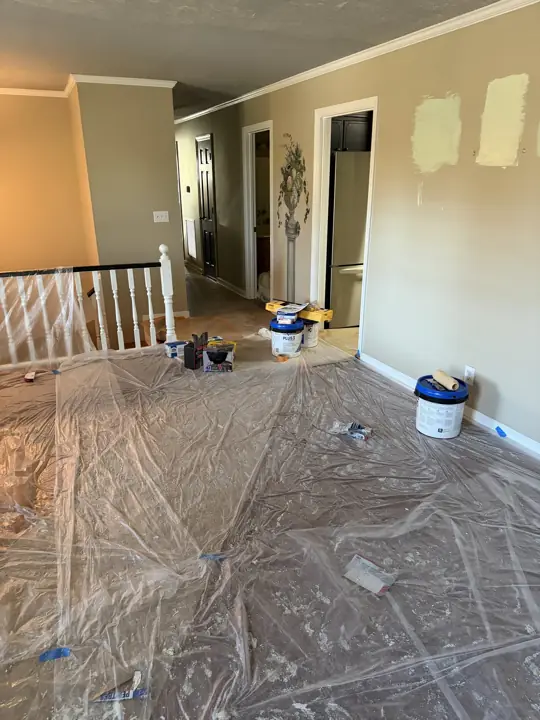 Paint sample patches on tan wall with floors under plastic in Chattanooga, TN