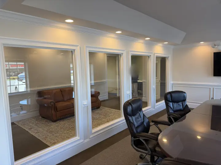 White-trimmed glass openings and wainscoting along conference room wall in a Cleveland, TN office