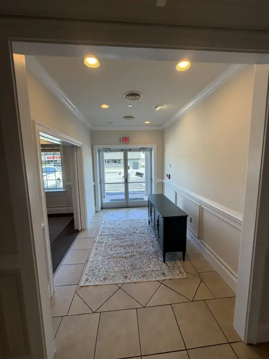 Office entry lobby with cream walls, white wainscoting and crown molding after painting in Cleveland, TN