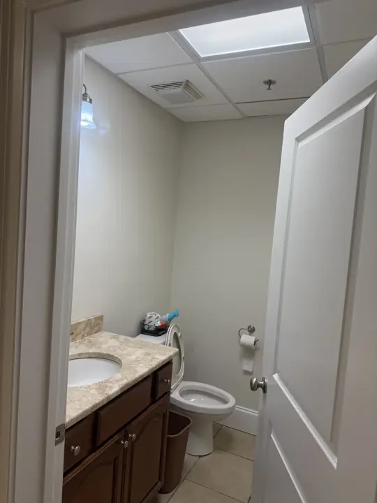 Office restroom with freshly painted cream walls and white door in Cleveland, TN