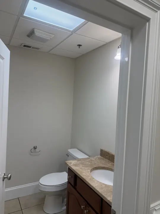 Office restroom with cream walls and white baseboard and door casing in Cleveland, TN