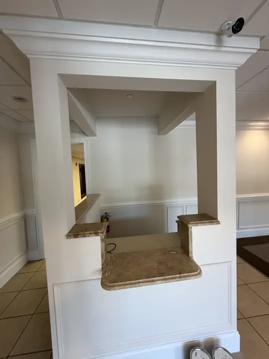 Painted reception counter enclosure with crown and panel molding in a Cleveland, TN office