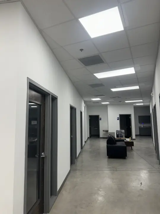 White office corridor with charcoal door frames leading to a lounge area in North Chattanooga, TN