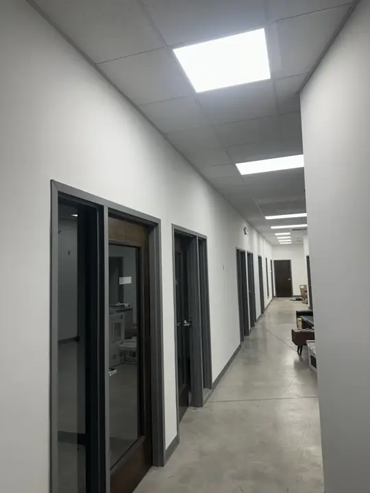 Row of office doors with charcoal frames along freshly painted white walls in North Chattanooga, TN