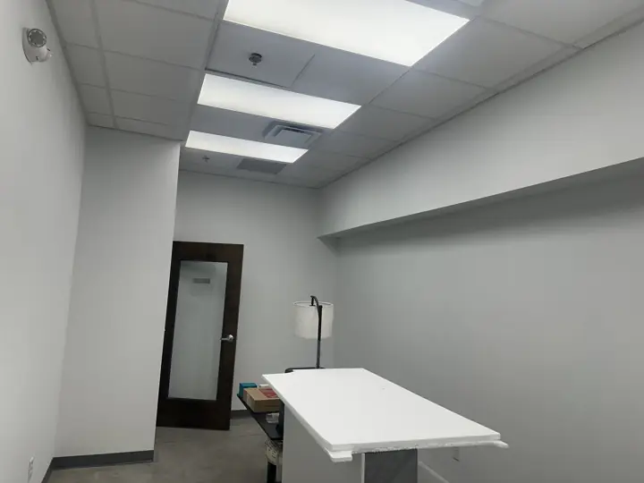 Private office with white walls and soffit after painting, wood door with frosted glass, North Chattanooga, TN