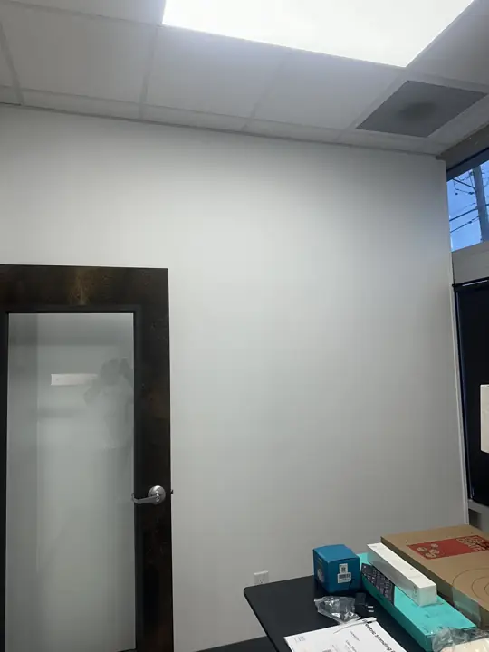White painted office wall beside a dark wood door with frosted glass in North Chattanooga, TN