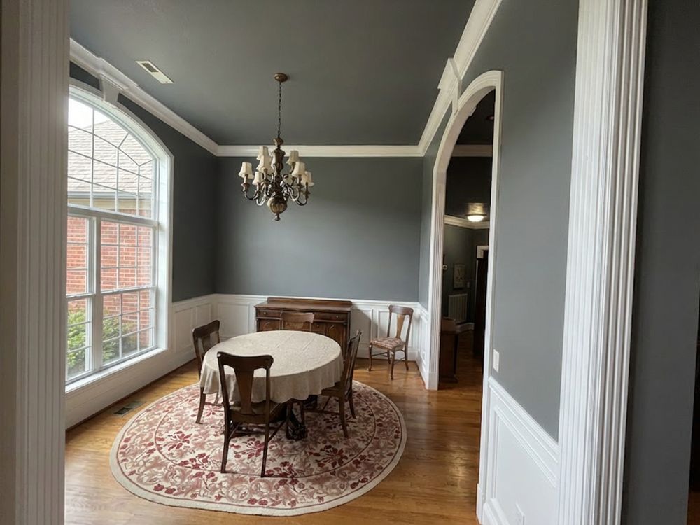 Dining room with an arched window and chandelier