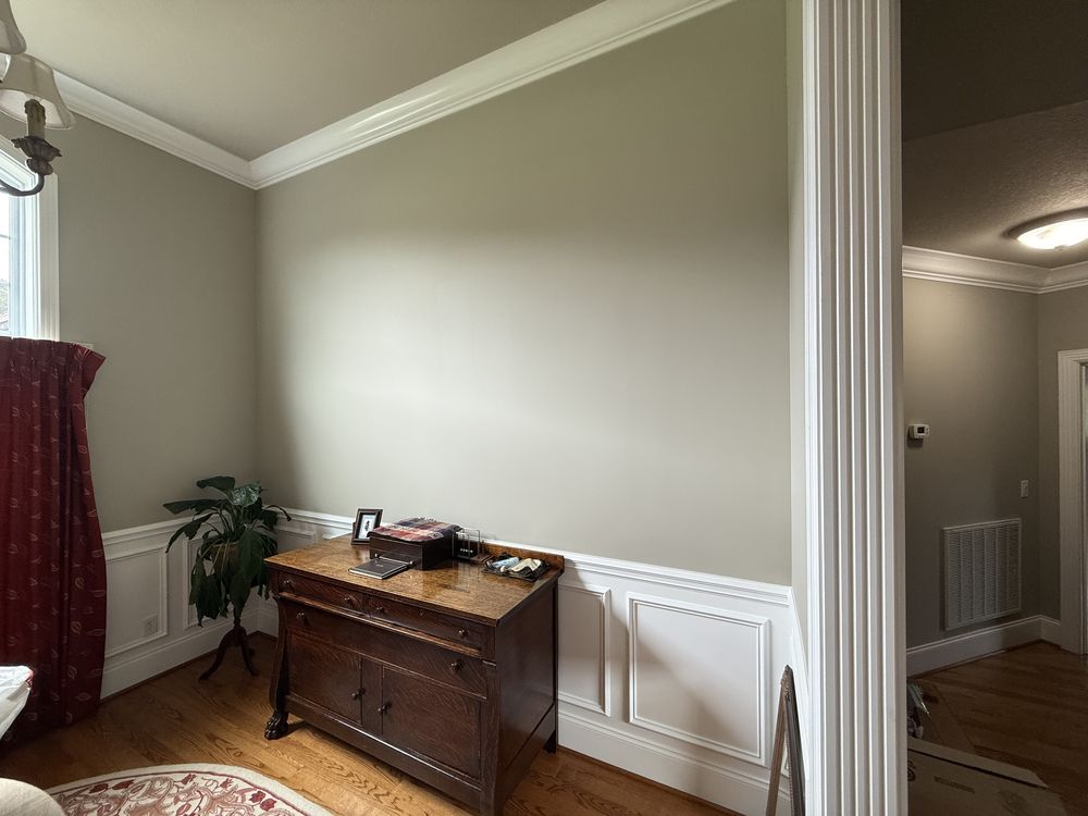 Room with sage-green walls and wainscoting