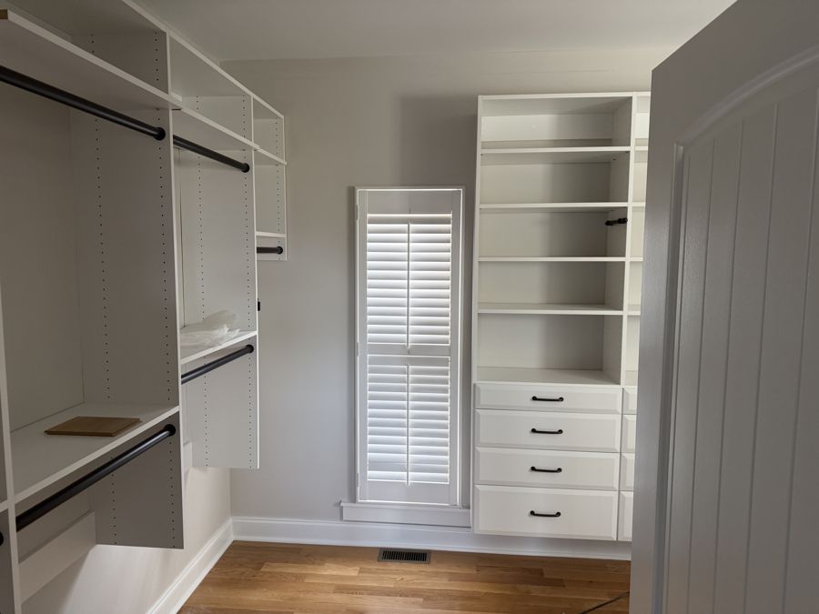Walk-in closet built-ins with drawers and shelving painted white in Harrison, TN