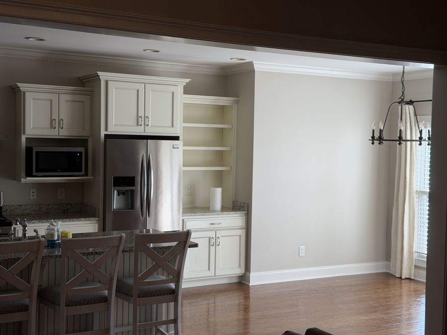 White painted kitchen cabinets and open built-in shelving in a Cleveland, TN home