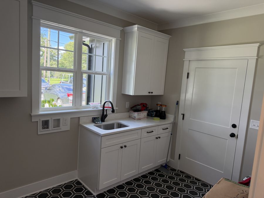 White shaker laundry room cabinets with matching uppers in Soddy-Daisy, TN