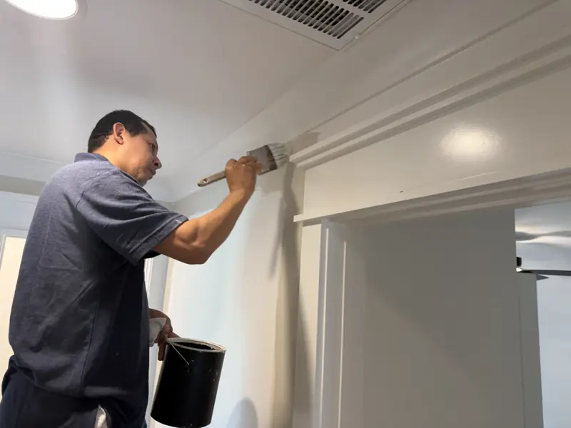 Painter brushing a door casing and crown detail in Soddy-Daisy, TN