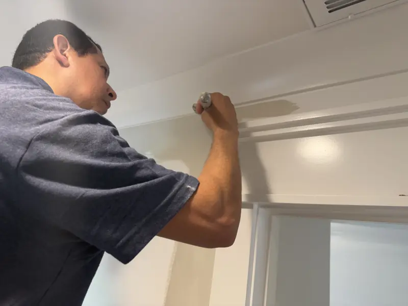 Close-up of a painter brushing interior trim in Soddy-Daisy, TN