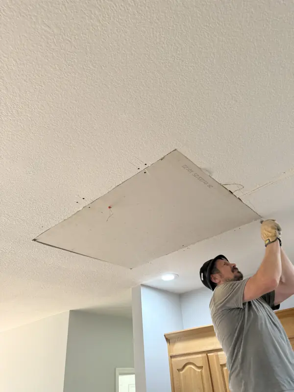 Painter repairing and patching a ceiling before paint in Ooltewah, TN