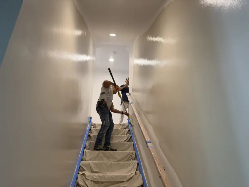 Painters working a long stairway with protected treads in Soddy-Daisy, TN