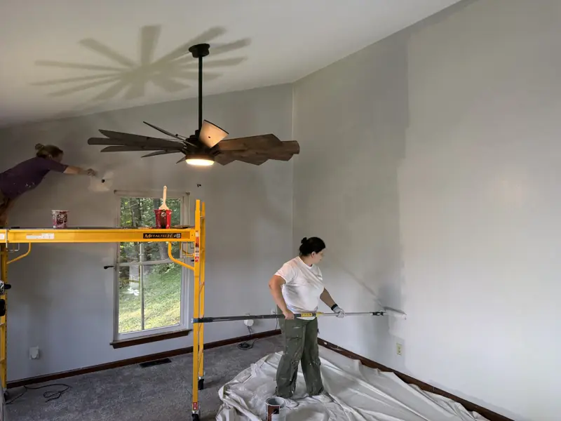 Two painters working walls and ceiling from a rolling scaffold in Chattanooga, TN
