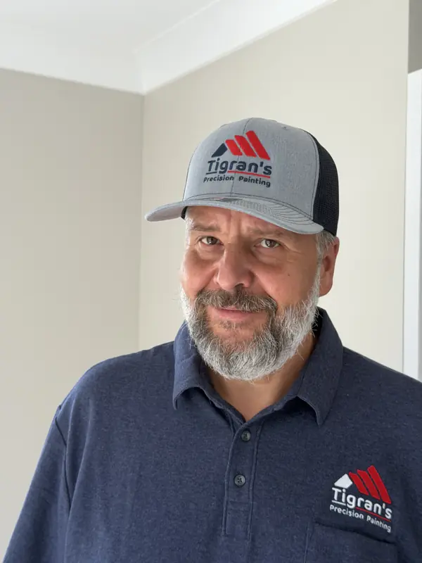 Tigran's Precision Painting crew member in company cap and shirt