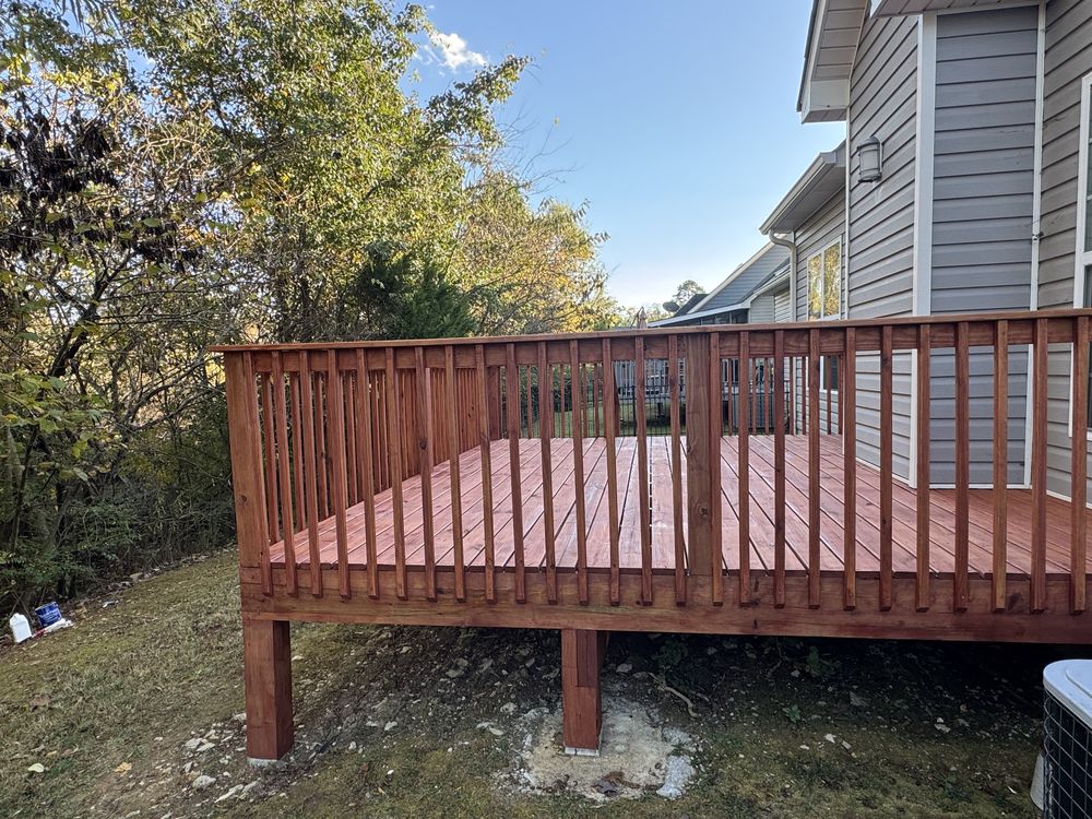 Multi-level backyard deck with a rich reddish-brown stain, full side view