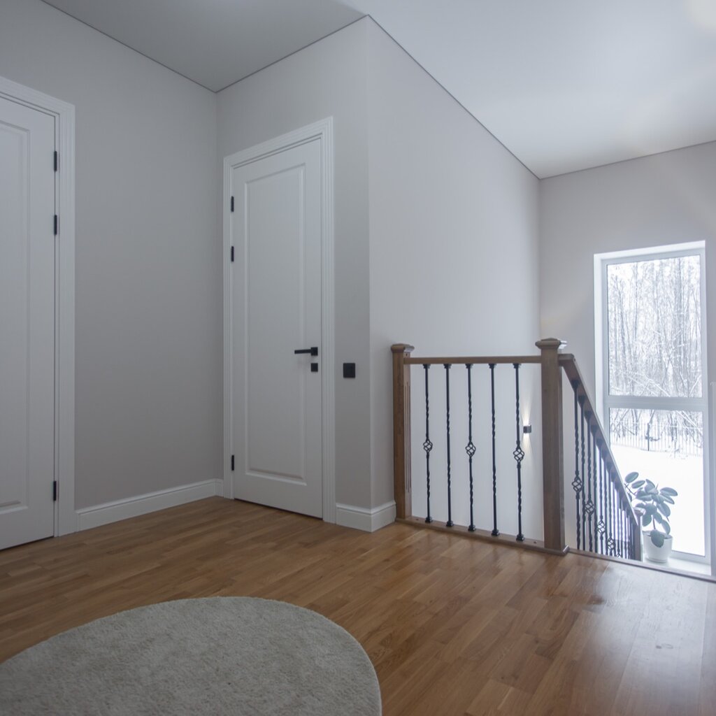 Two-story foyer with arch window and hardwood floors